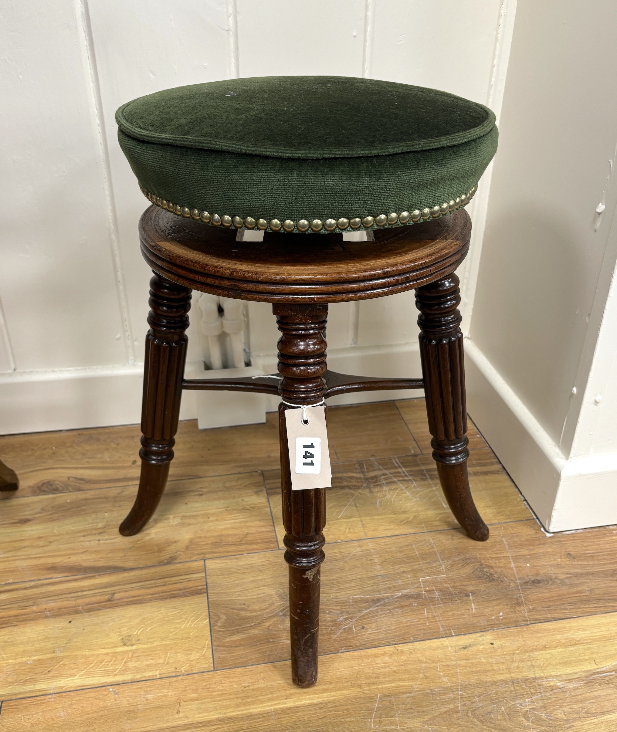 A Regency mahogany revolving adjustable piano stool